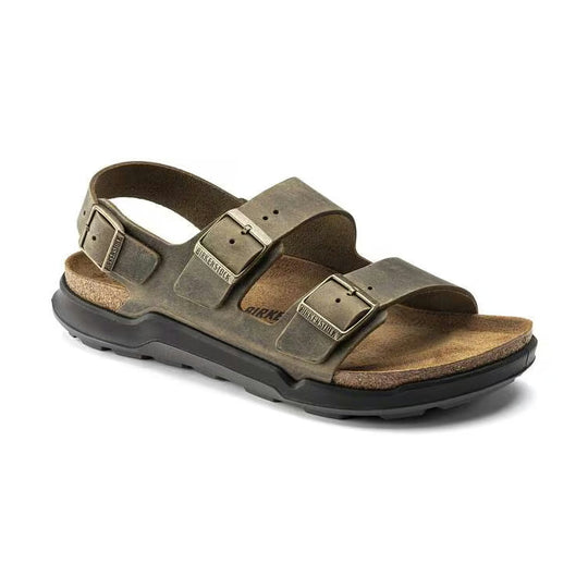 A single Birkenstock Milano Crosstown sandal in distressed olive brown leather with a black outsole, shown from a three-quarters angle on a white background.