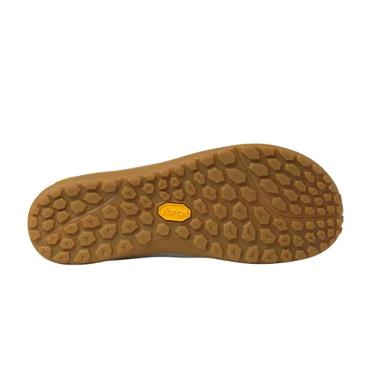 A close-up of a brown textured shoe sole with a small yellow Vibram logo in the center, shown against a plain white background.