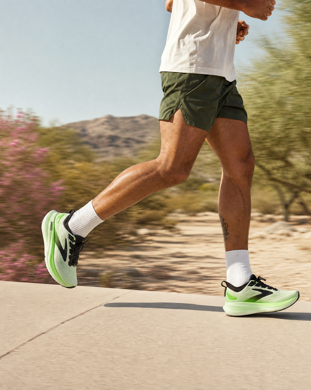 Person running outdoors with Brooks Mens Glycerin 23 green shoes and white socks