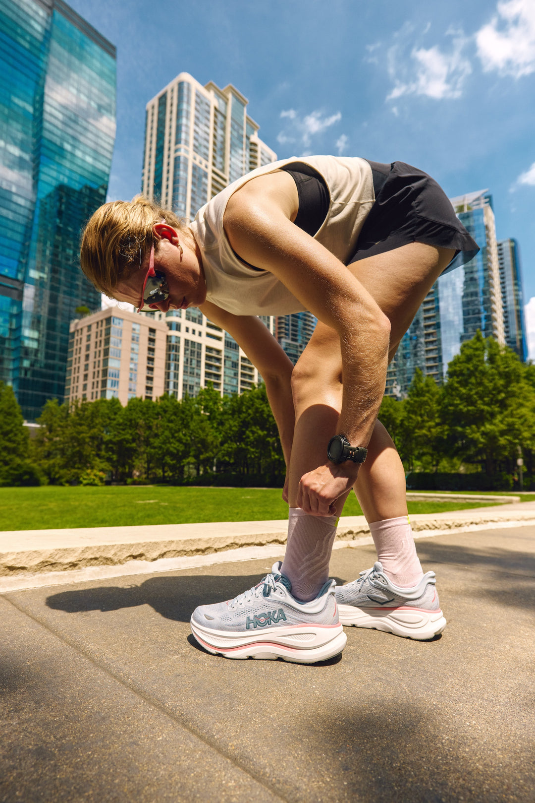 Person stretching outdoors with city skyline in the background