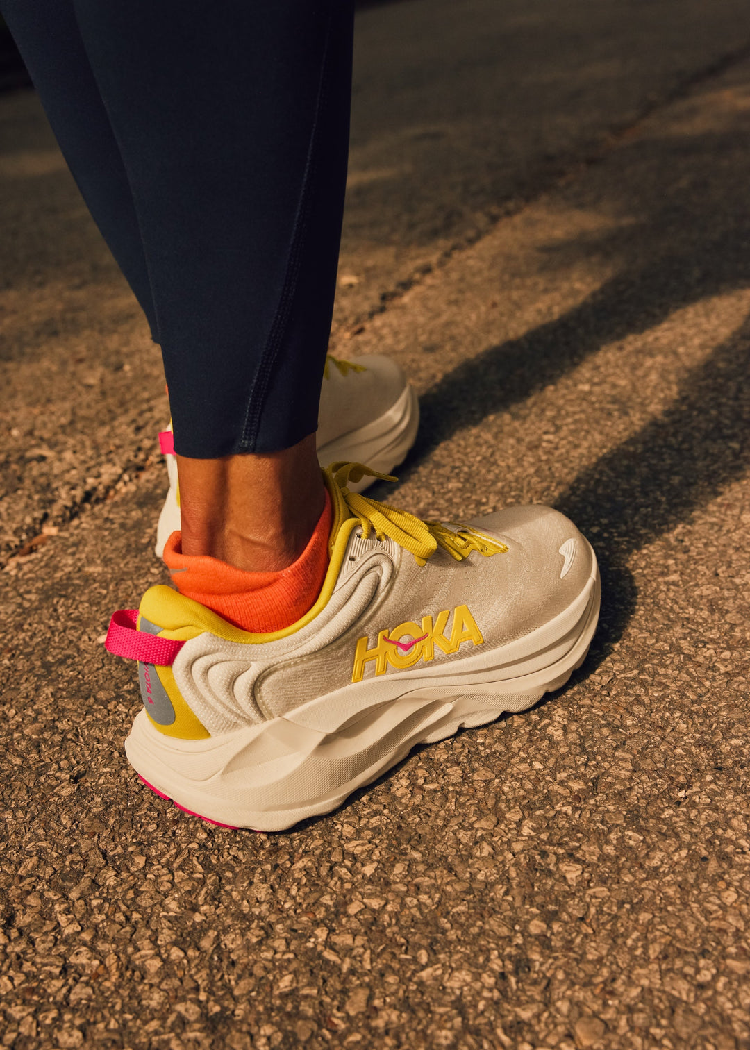 Person wearing colorful Hoka Gaviota 6 sneakers on a pavement background