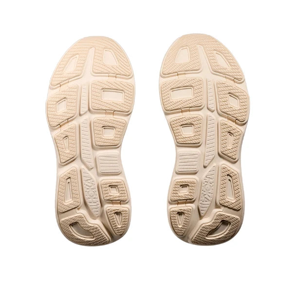 The outsoles of a pair of beige Hoka Bondi 9 – Women&