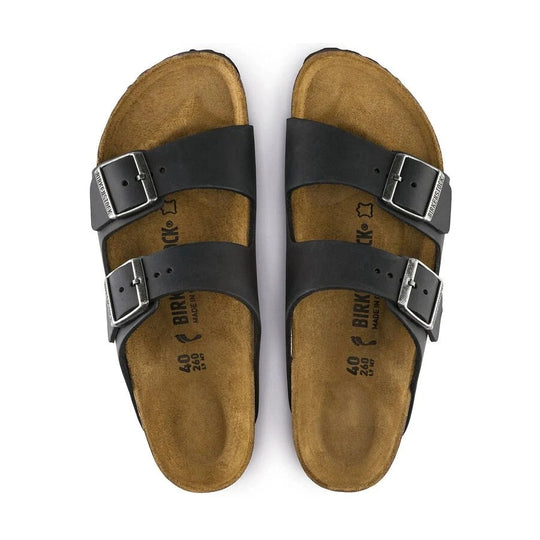 Pair of black BIRKENSTOCK Arizona sandals with black straps on a white background