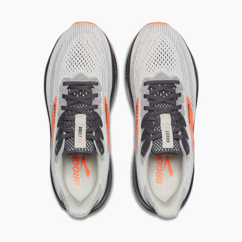 A pair of Brooks Ghost 17 – Men's running shoes shown from a top-down view on a light gray background. The shoes feature a light gray and white mesh upper with dark gray laces, orange side accents, and an orange Brooks logo on the tongue and footbed.