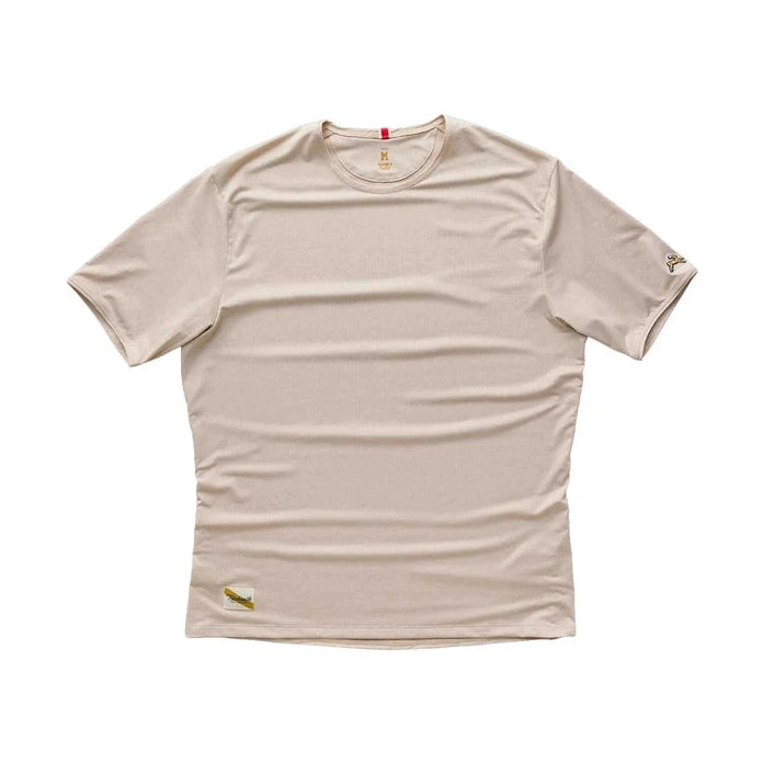 A beige Twilight Tee – Men's athletic t-shirt with small gold embroidered logos on the left sleeve and lower hem, displayed flat against a white background.