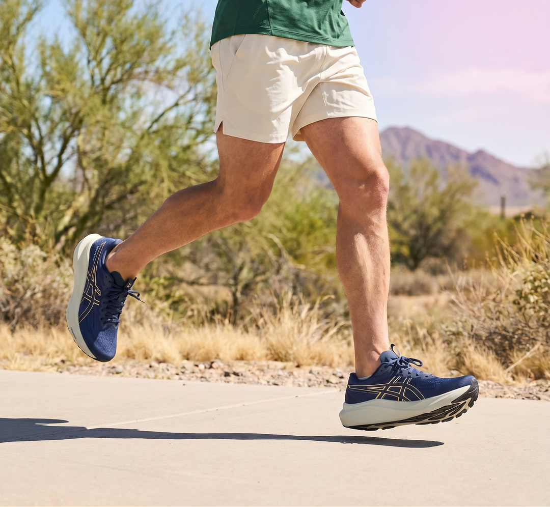 Person running on a road with desert landscape in the background
