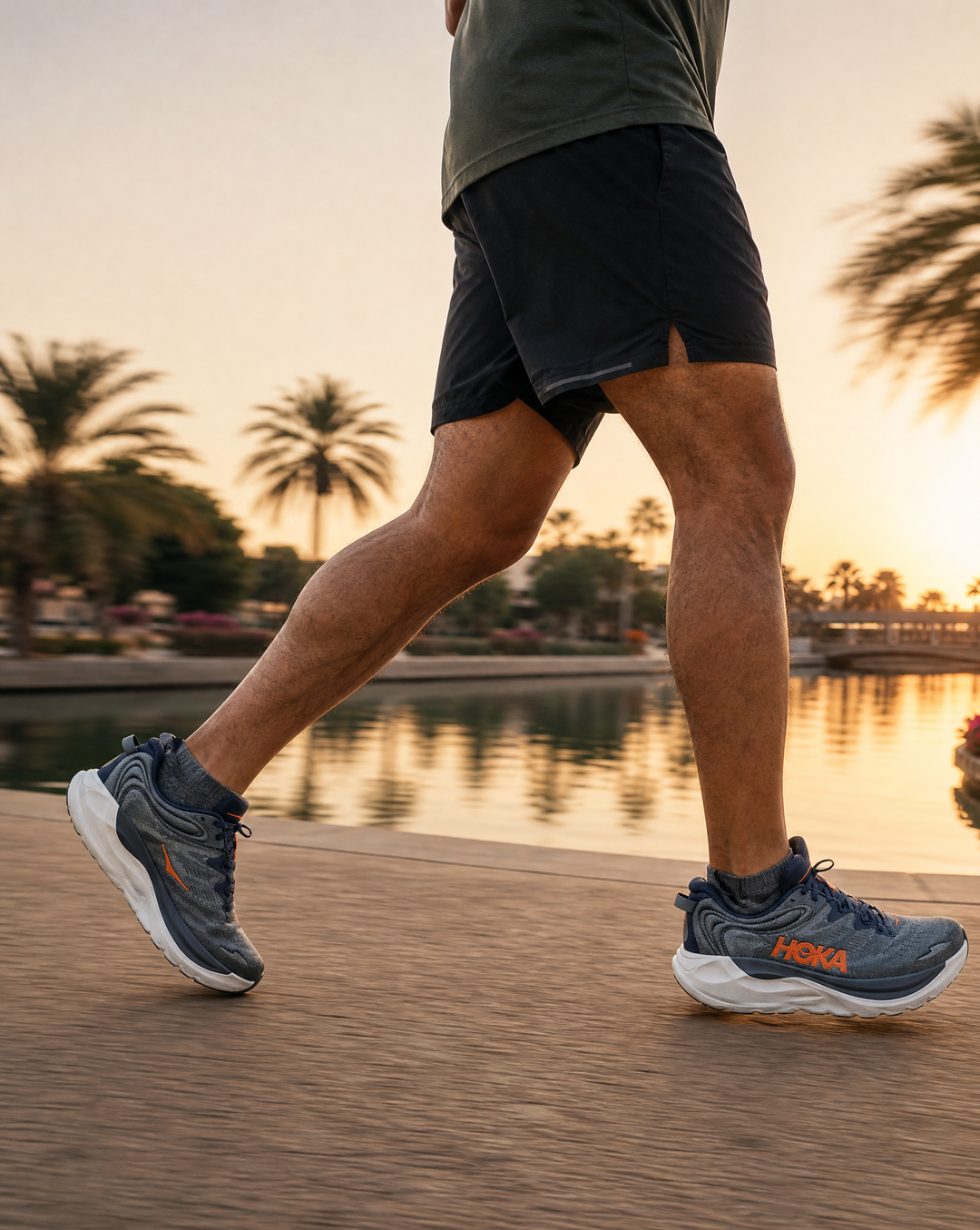 Person running on a path in Hoka Gaviota 6 shoes with palm trees and a lake in the background