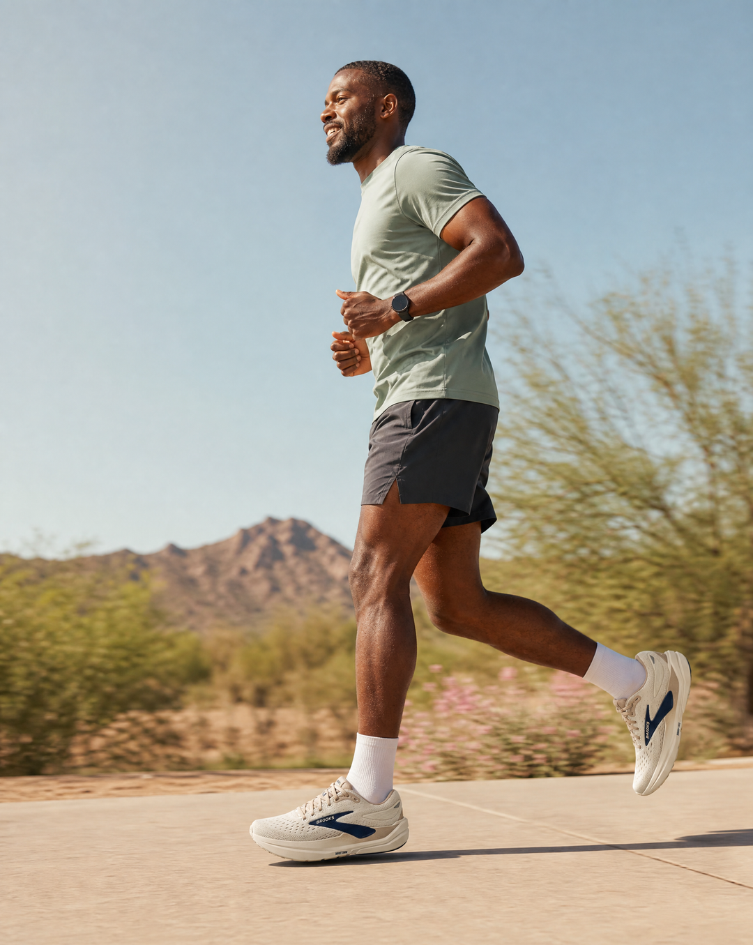 Man running outdoors In Brooks Ghost Max 3 with mountains and desert landscape in the background