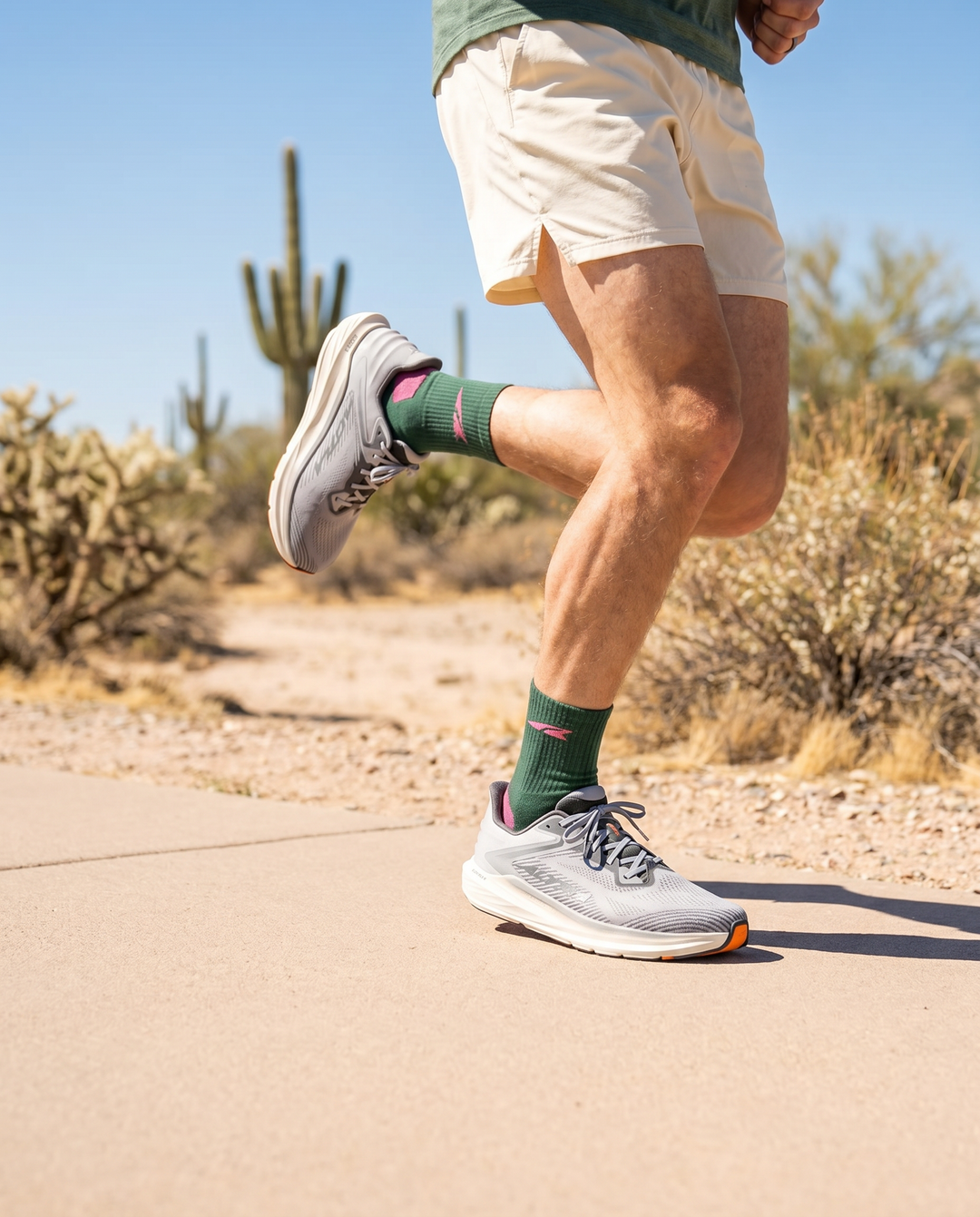 Person running on a path with desert landscape in the background