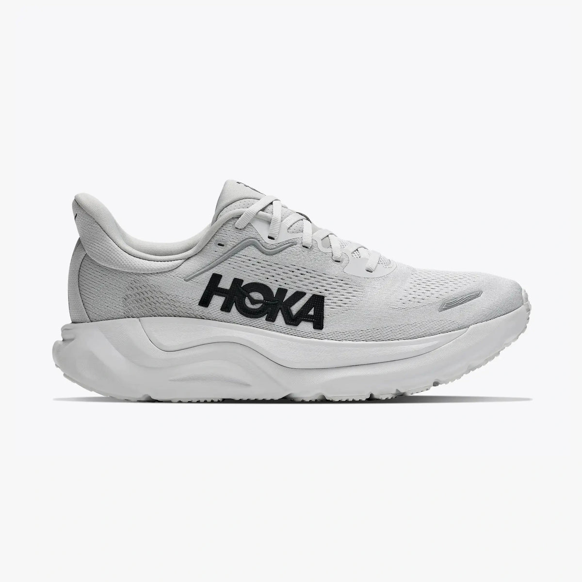 A Hoka Arahi 9 -- Men's running shoe in white and light gray with a prominent black HOKA logo on the side, shown against a plain light gray background.