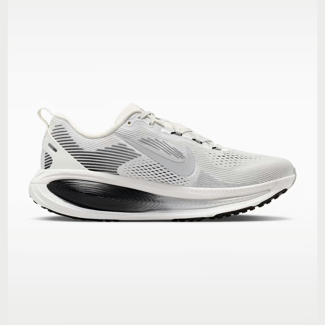 A Nike Vomero 18--Men's running shoe in white and light gray with a black and gray midsole, shown from a side profile on a light gray background.