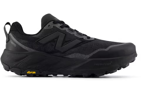 A black New Balance Fresh Foam X Hierro V9 trail running shoe with a thick black midsole, black laces, and a small yellow Vibram logo on the outsole, shown against a plain white background.
