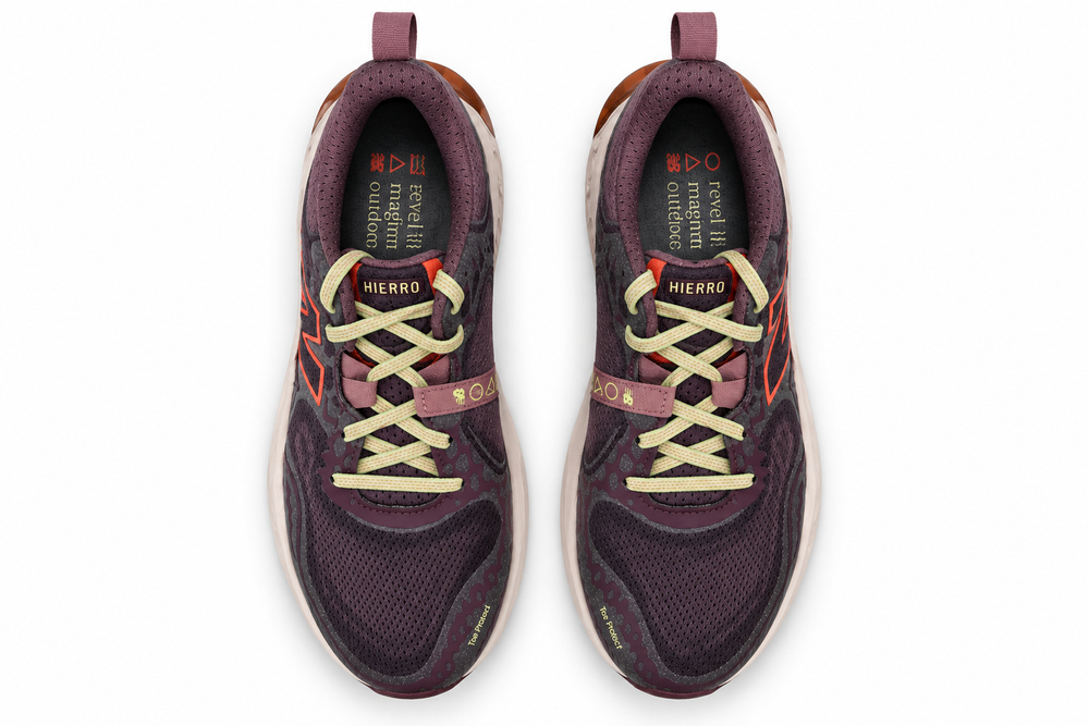 A pair of New Balance Hierro V8 – Women's Shoes in a deep plum purple colorway, featuring cream-colored laces and orange accents, shown from a top-down view on a white background.