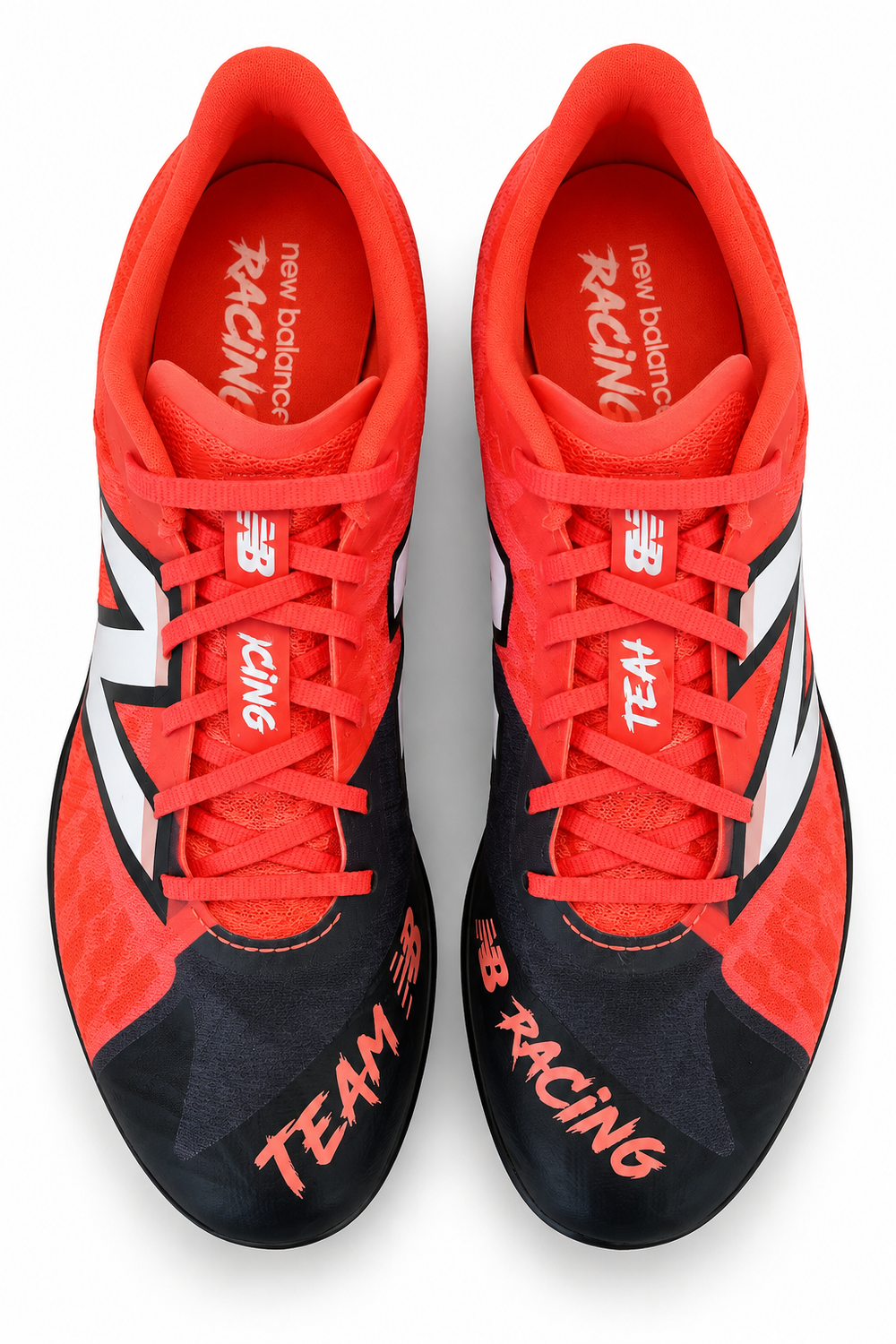 A pair of New Balance Sd100 V5 – Men's racing shoes in vibrant red and black, featuring white side stripes, red laces, and 'TEAM RACING' text on the toe boxes, shown from a top-down view on a white background.