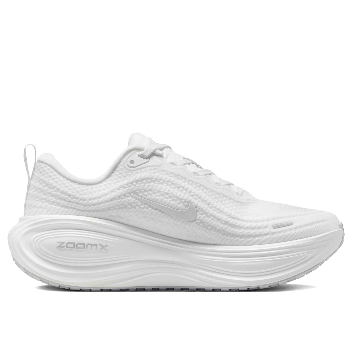A white Nike Vomero Plus - Women's running shoe with a thick, cushioned white sole featuring the 'ZOOMX' text, shown from a side profile on a solid white background.