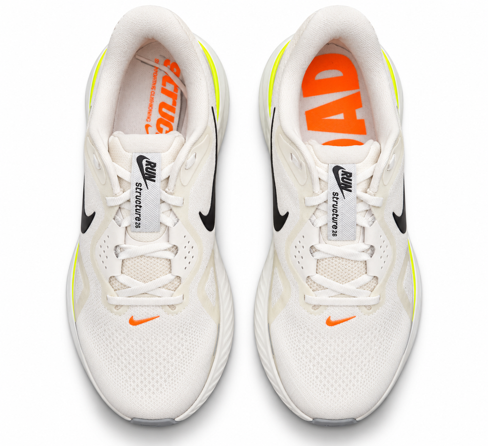 A pair of Nike Structure 26 – Men's running shoes in white, featuring black Swooshes, orange logo accents, and a neon yellow heel detail, shown from a top-down view on a white background.