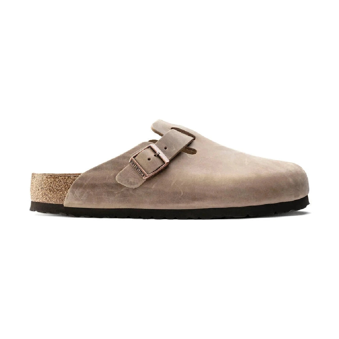 A taupe suede Birkenstock Boston Soft Footbed clog-style mule shoe with a double strap buckle closure and a cork-look midsole, shown against a plain white background.