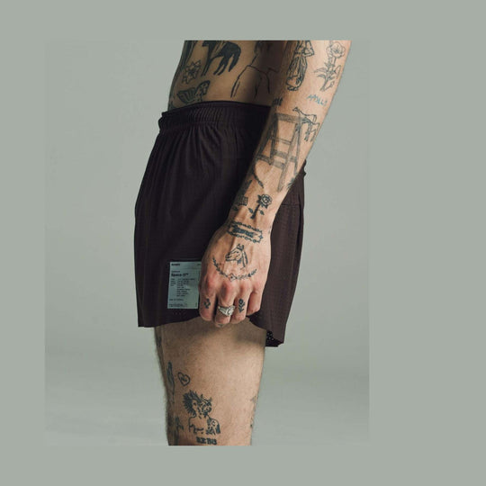 A close-up side view of a person wearing dark brown Space-O Shorts--Men&