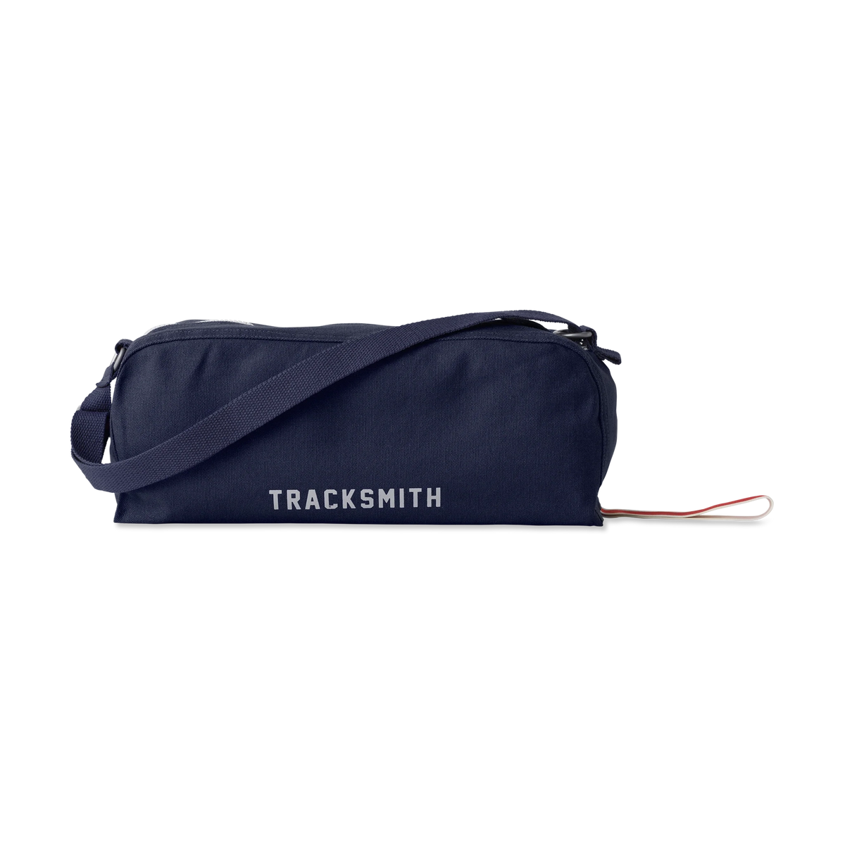 A navy blue cylindrical Shoe Bag with the brand name 'TRACKSMITH' printed in white on the front, featuring a matching navy strap and a small red-and-white loop pull.