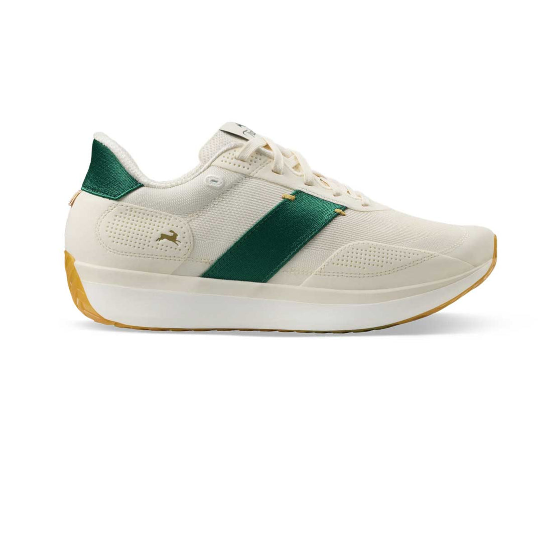 A low-top sneaker in off-white Tracksmith Eliot Ryder – All Gender  with a prominent dark green side stripe, a green heel tab, and a gum-colored outsole, shown from a side profile on a white background.