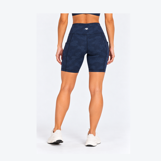 Rear view of a model wearing 7" Running Bike Short – Women&