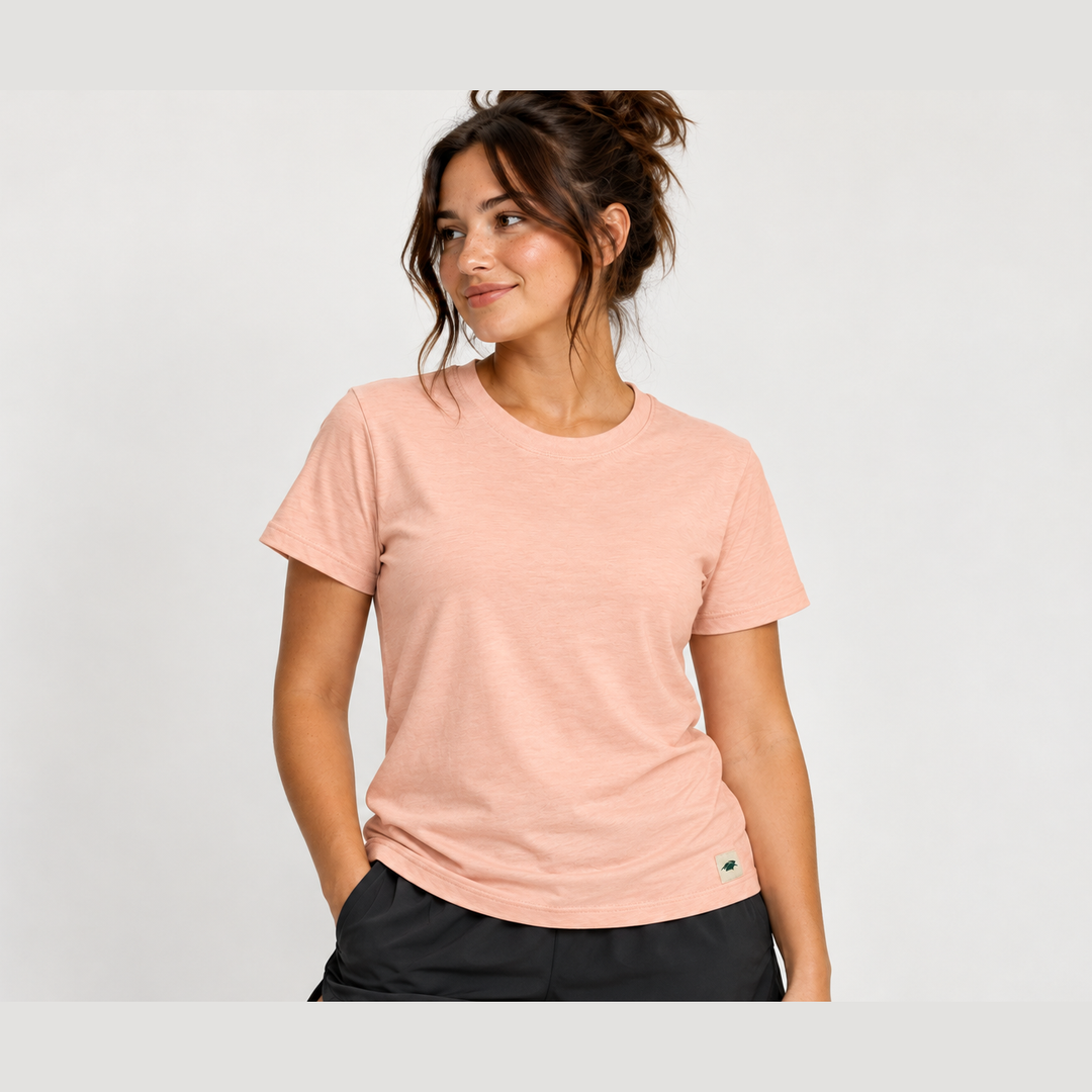 A woman wearing a light peach Classic Fit Tee – Women&