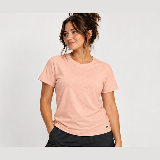 A woman wearing a light peach Classic Fit Tee – Women&