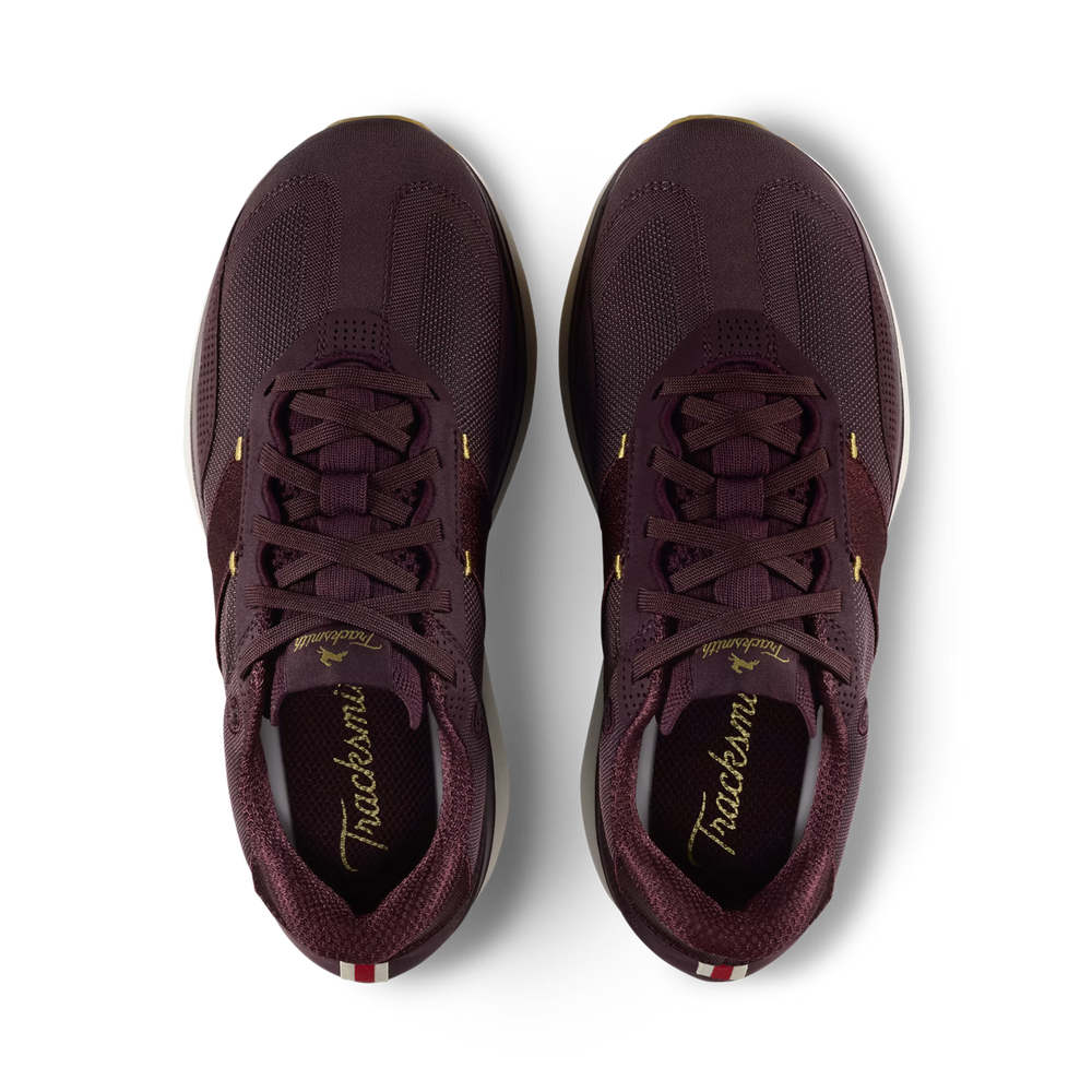 A pair of Tracksmith Eliot Ryder – All Gender athletic sneakers in a deep burgundy color, shown from a top-down view on a clean white background.