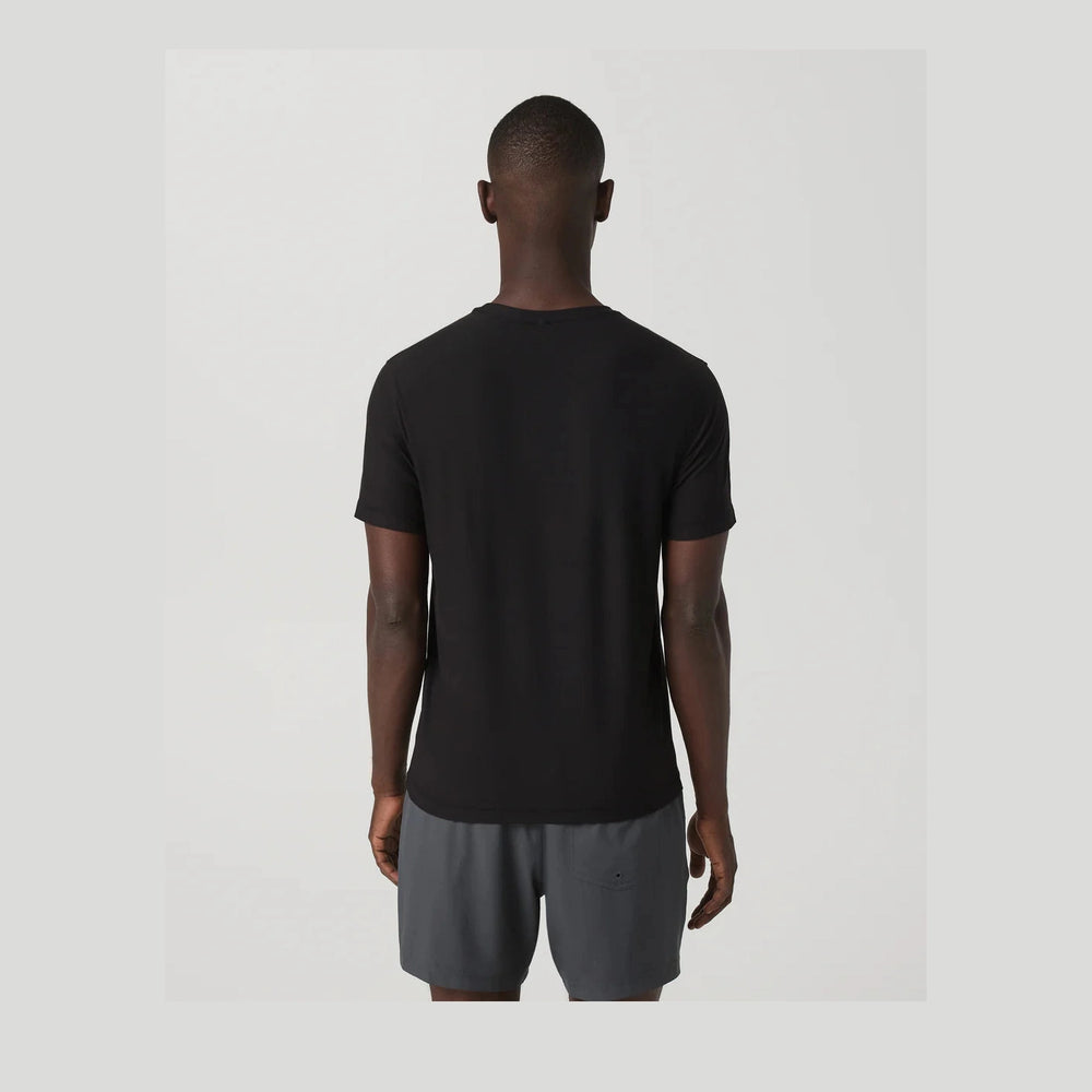 Person wearing a black Strato Tech Tee – Men's t-shirt and gray shorts on a light gray background