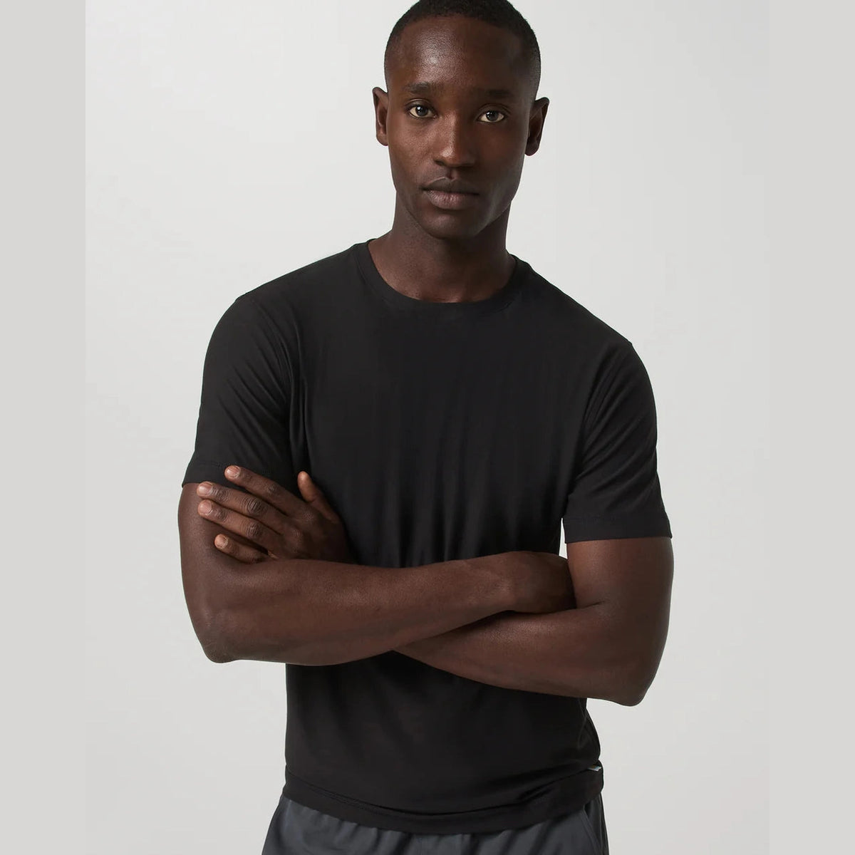 Man wearing a black Strato Tech Tee – Men's t-shirt against a plain background