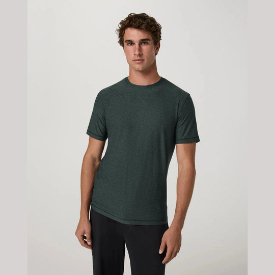A man wearing a dark green Strato Tech Tee – Men&