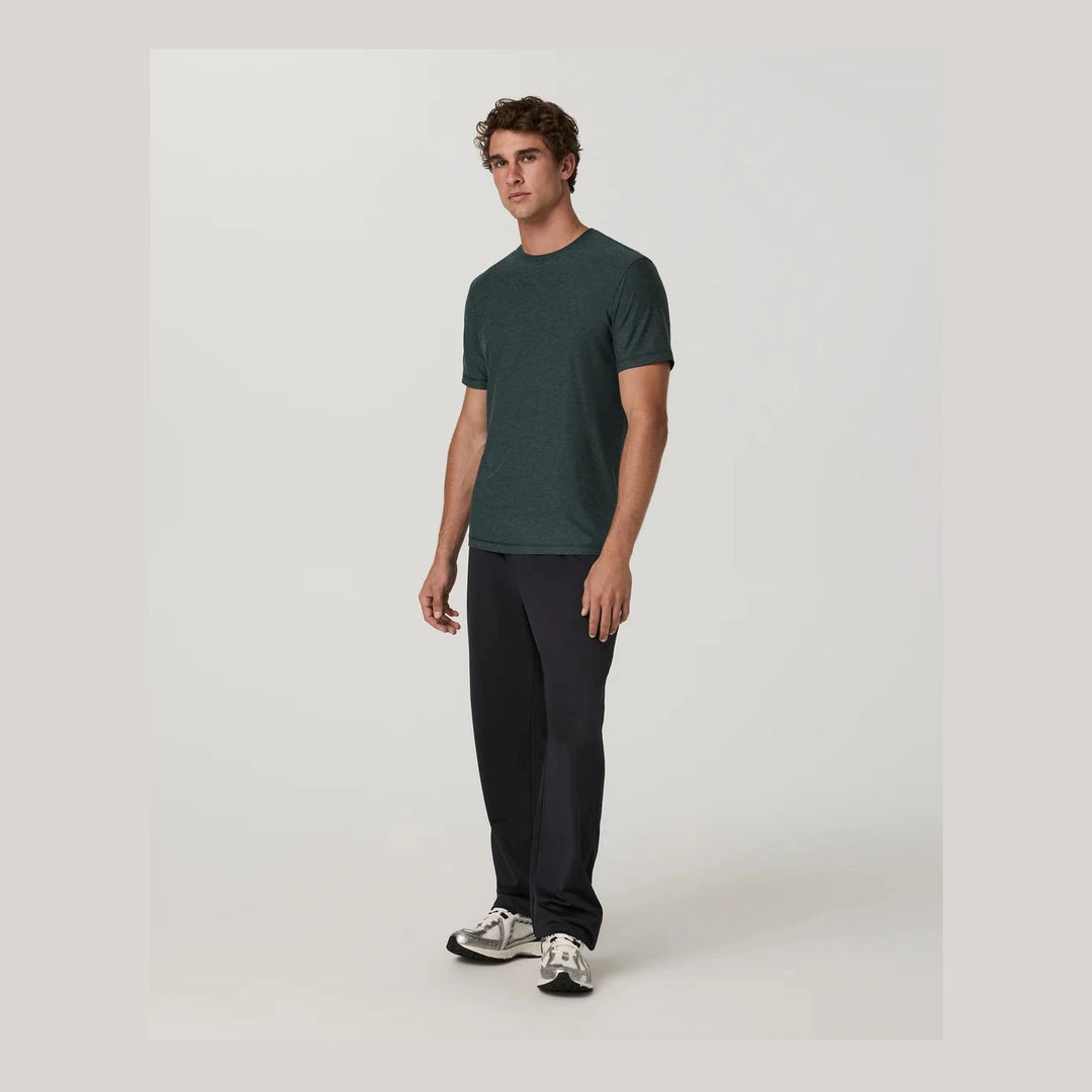 A man modeling a dark green Strato Tech Tee – Men&