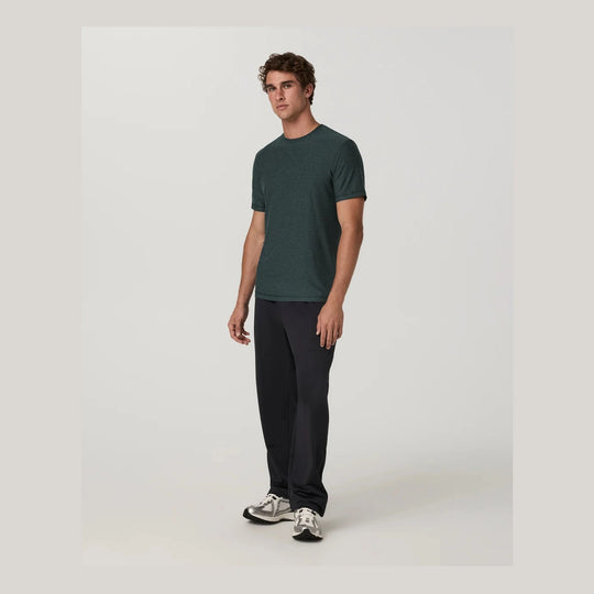 A man modeling a dark green Strato Tech Tee – Men&