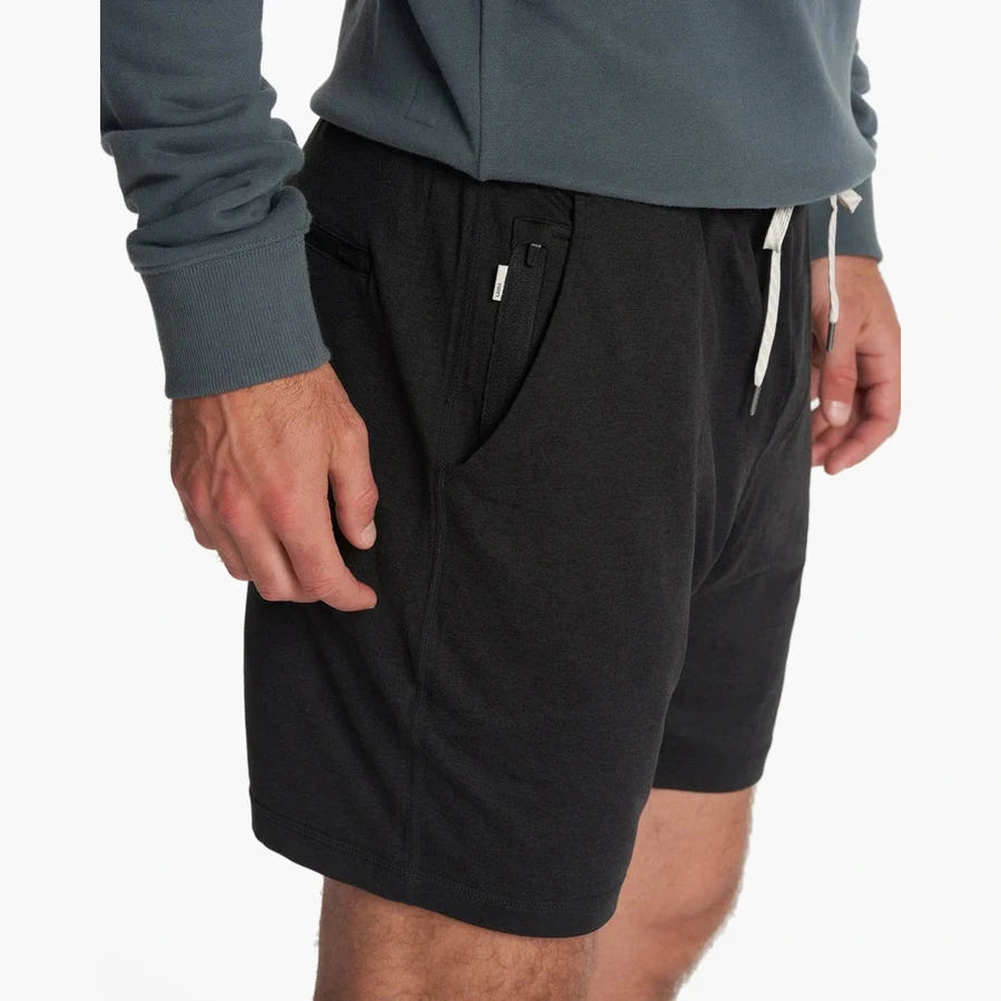 Person wearing black Vuori Ponto Short – Men's shorts with a plain background
