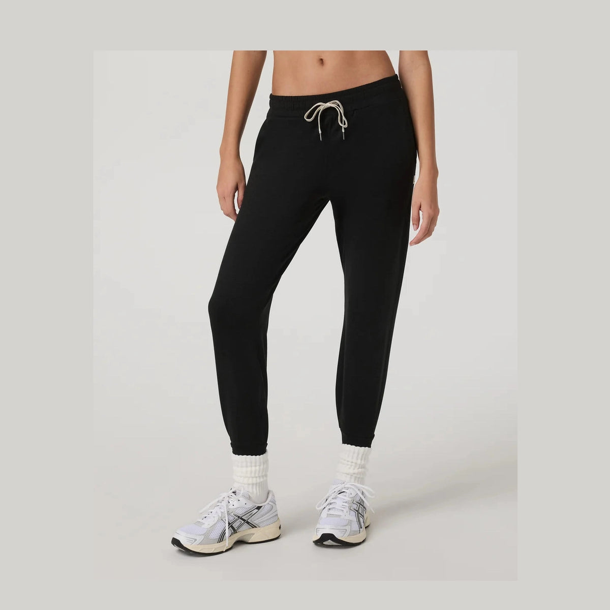 Person wearing black Vuori Performance Jogger Long – Women's jogger pants on a plain background