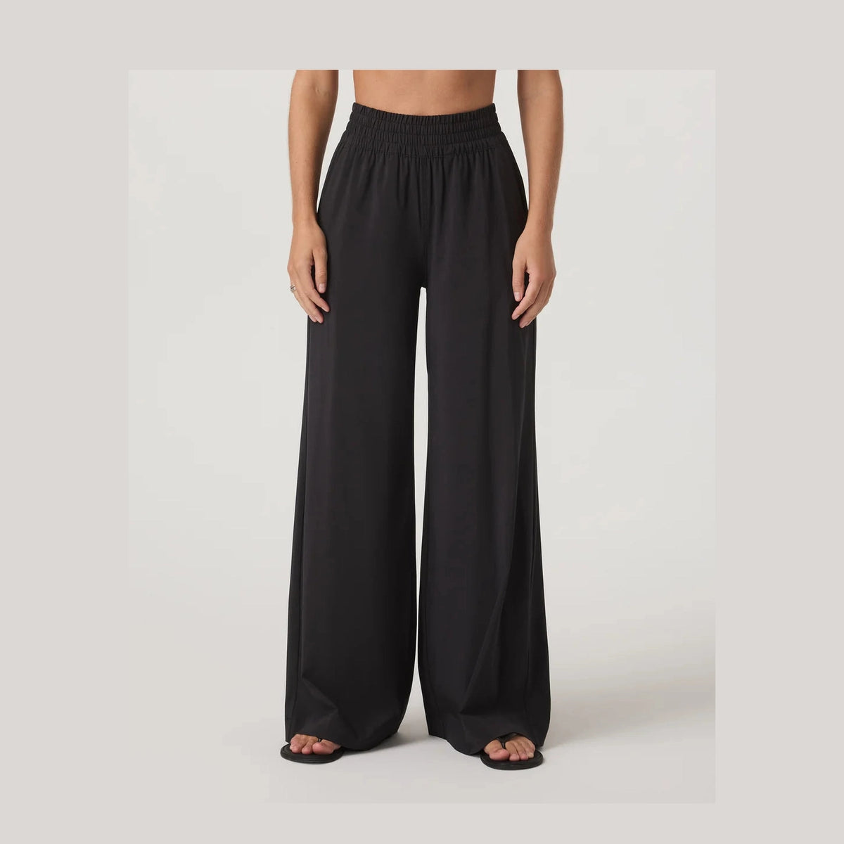 Black wide-leg Vuori Villa Wideleg – Women's pants worn by a person on a white background