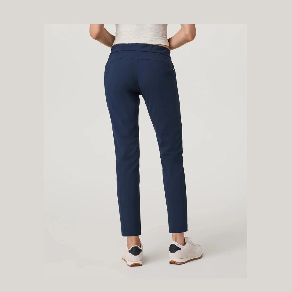 Navy blue pants worn by a person on a light gray background