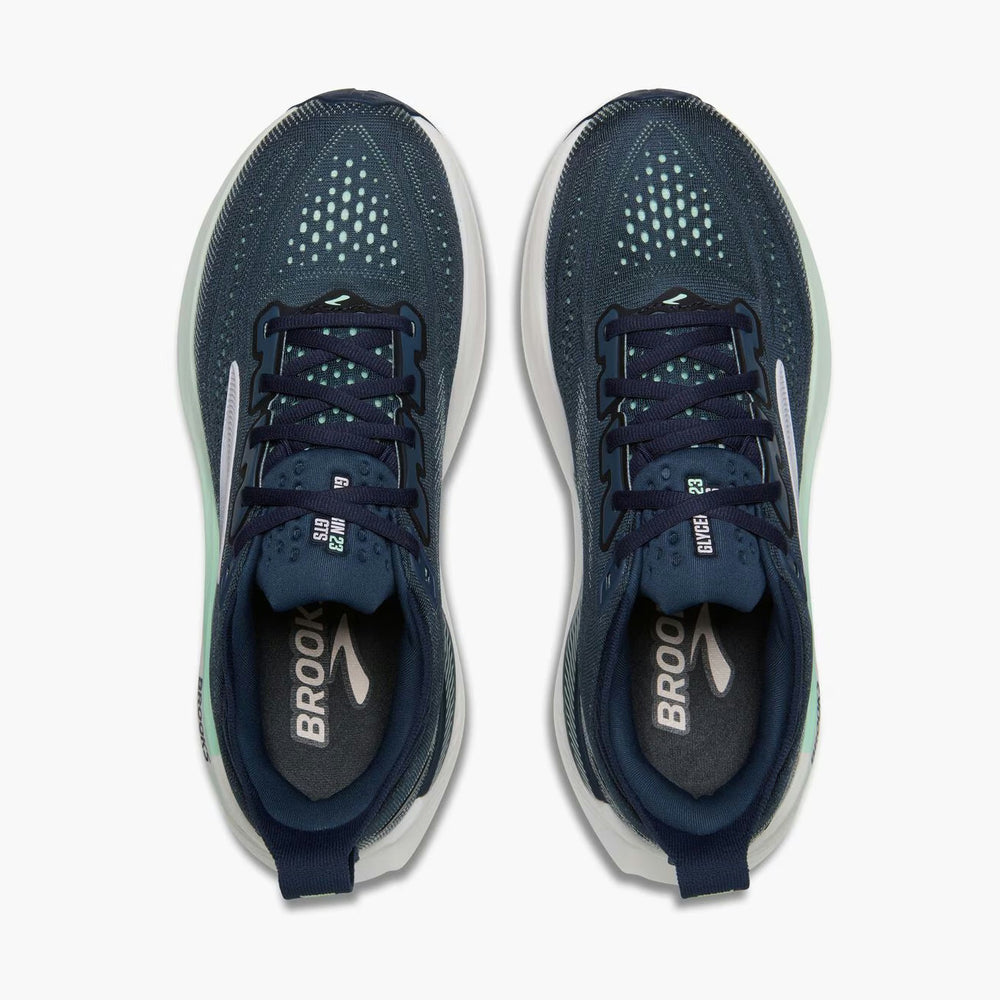 A pair of Brooks Glycerin Gts 23 – Women's unning shoes shown from a top-down view, featuring a dark navy blue mesh upper with a subtle mint green tint, a white midsole, and the brand name 'BROOKS' printed on the insoles.