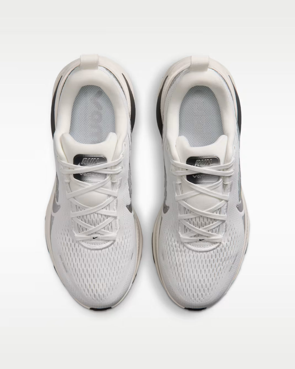 A pair of Vomero 18 --Women's running shoes in white and light gray, shown from a top-down view on a light gray background.