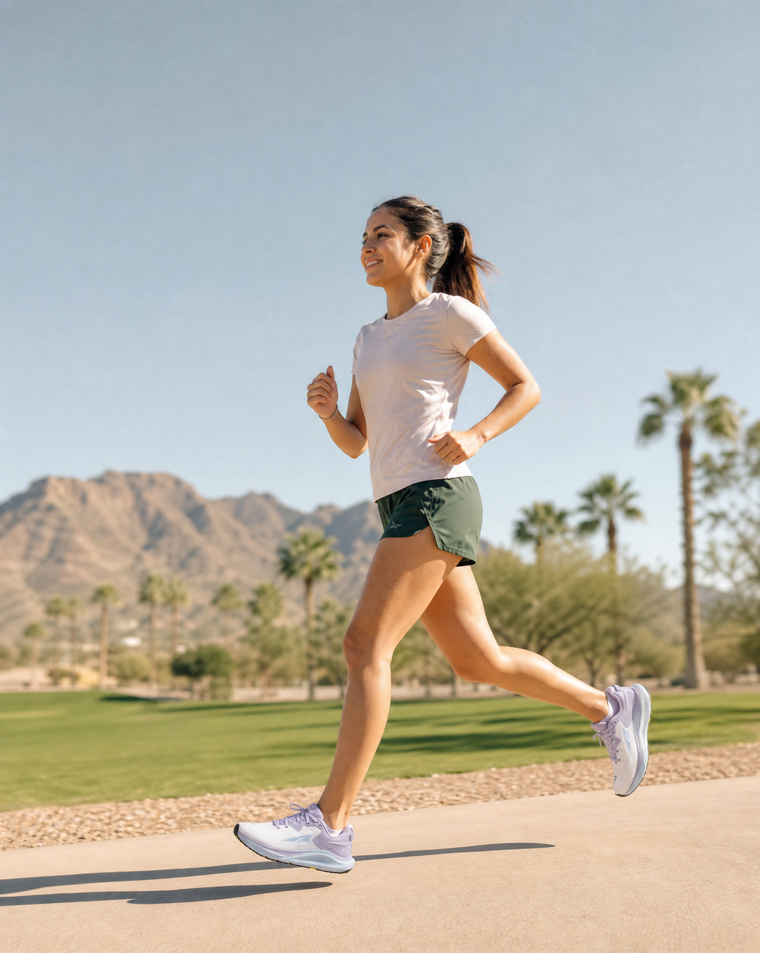 Woman running on a path with mountains and palm trees in the background