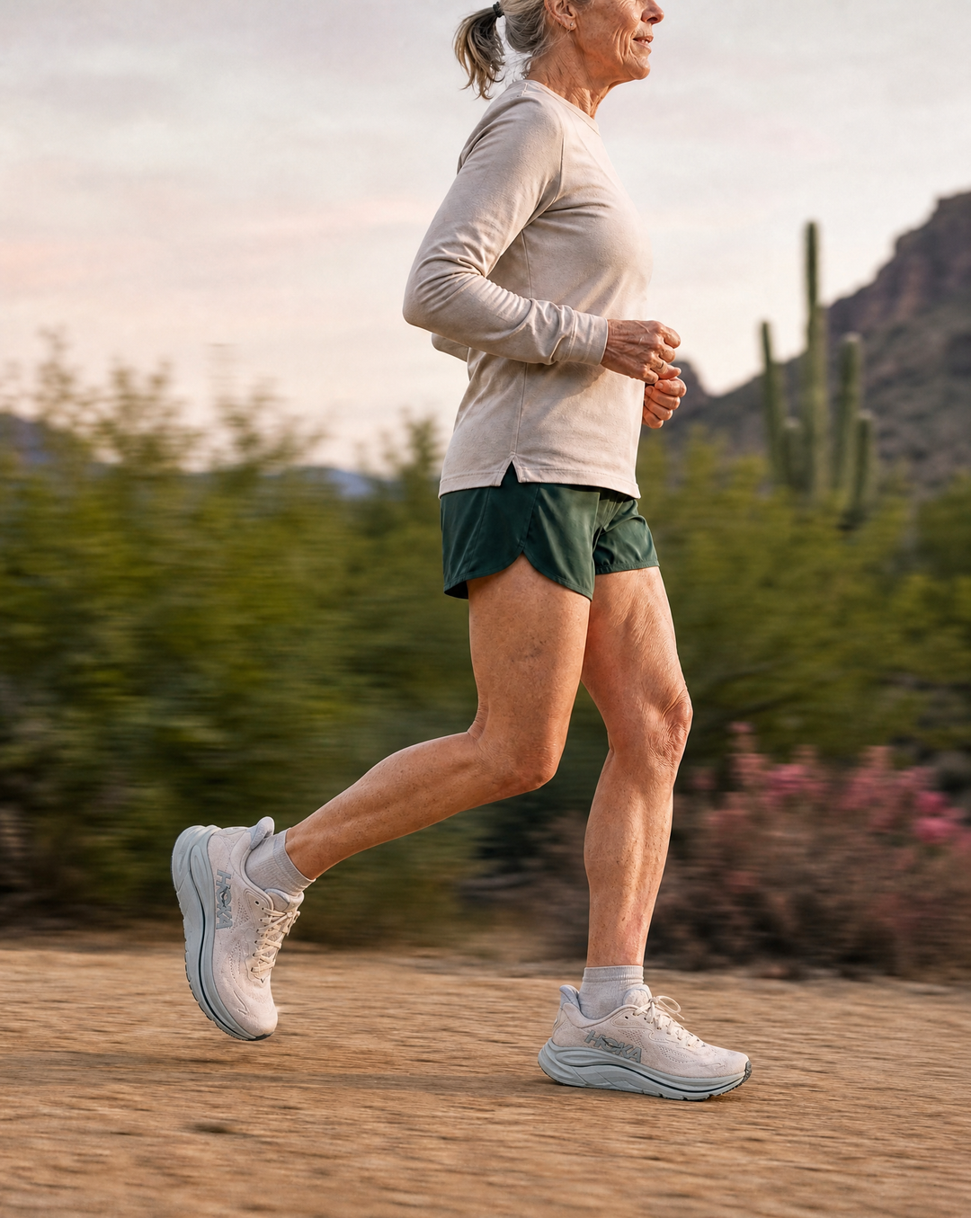 Person running outdoors in Hoka Women's Clifton 10
 with desert landscape in the background