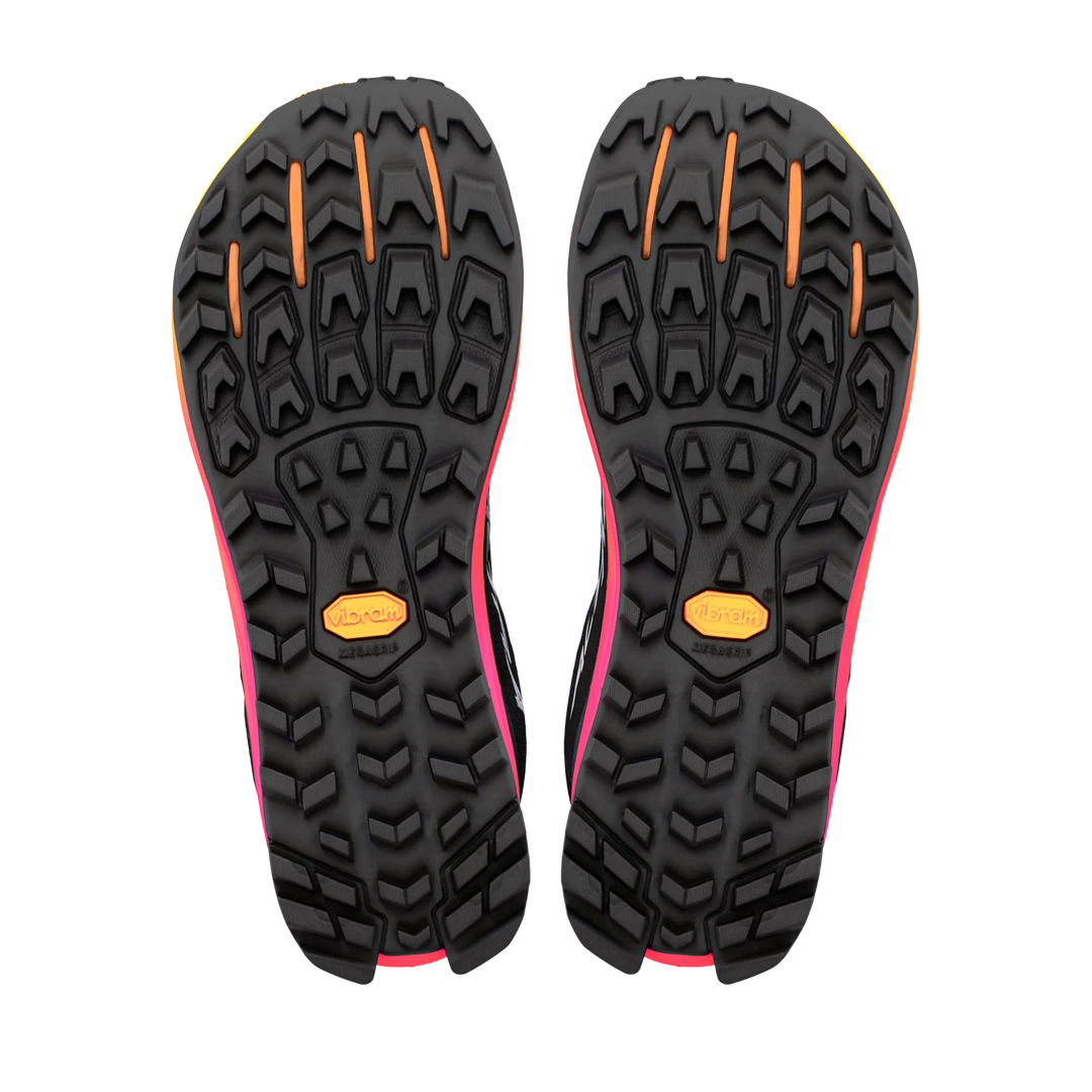 A pair of trail running shoes shown from the bottom, displaying their black Vibram soles with bright pink and orange accents.
