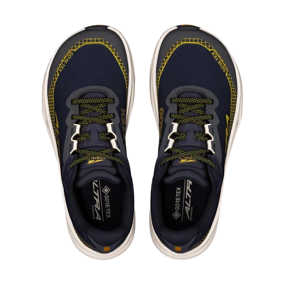 A pair of Altra Torin 9 GTX – Women's athletic shoes shown from a top-down view on a plain white background. The shoes are dark navy blue with bright yellow accents and white soles.
