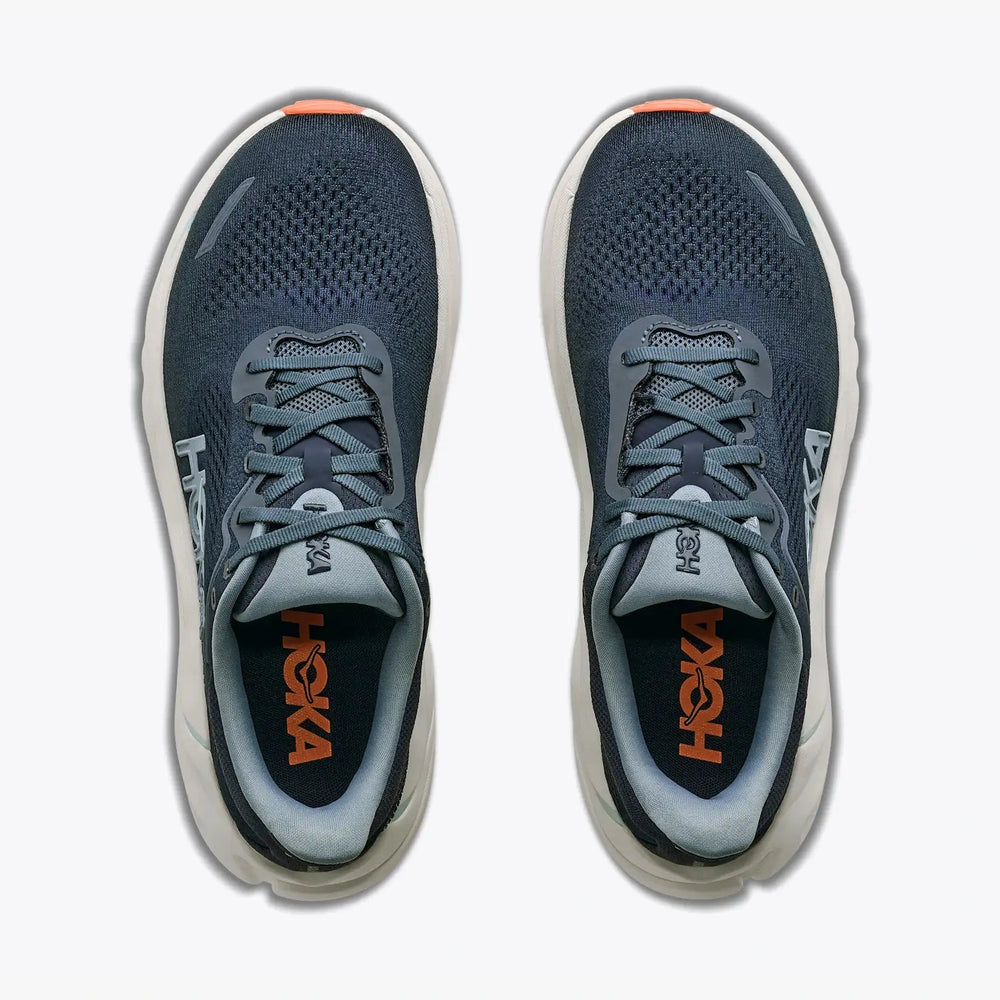 A pair of Arahi 9 -- Women's Hoka running shoes shown from a top-down view, featuring a dark slate blue mesh upper, gray laces, a white midsole, and orange branding on the inner sole.