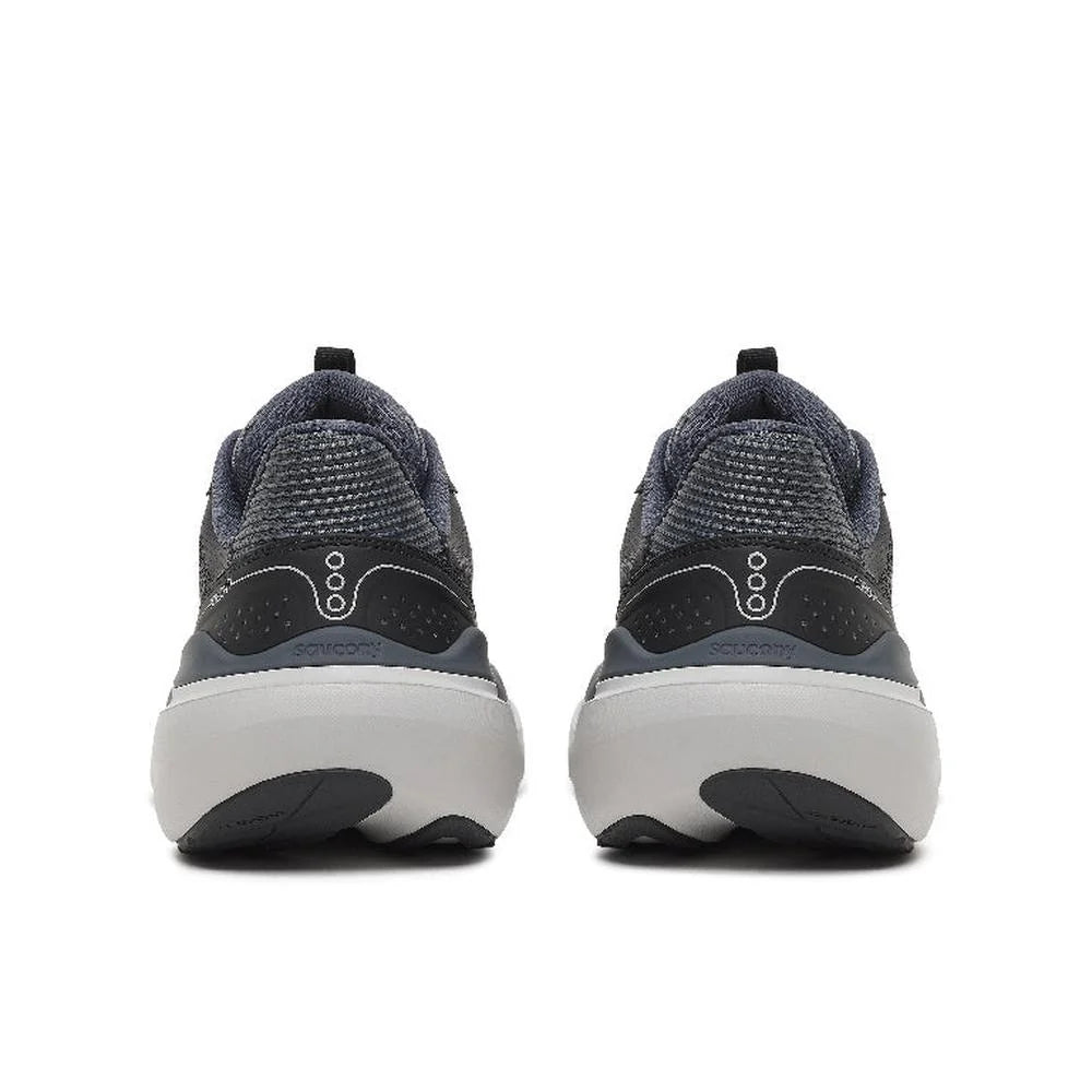 A pair of athletic sneakers shown from the rear, featuring a dark gray and black textured knit upper, a white midsole, and a small white logo on the heel.