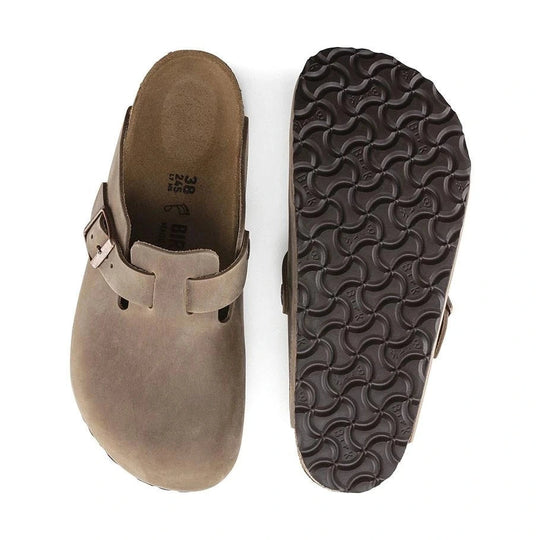 Brown Birkenstock Boston Soft Footbed leather clog shoe with sole showing texture on a white background