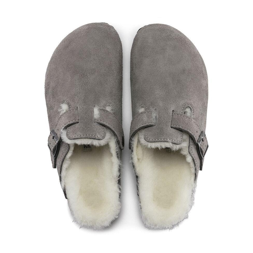 Pair of gray Birkenstock Boston Shearling--Suede Stone Coin with white fur lining on a white background