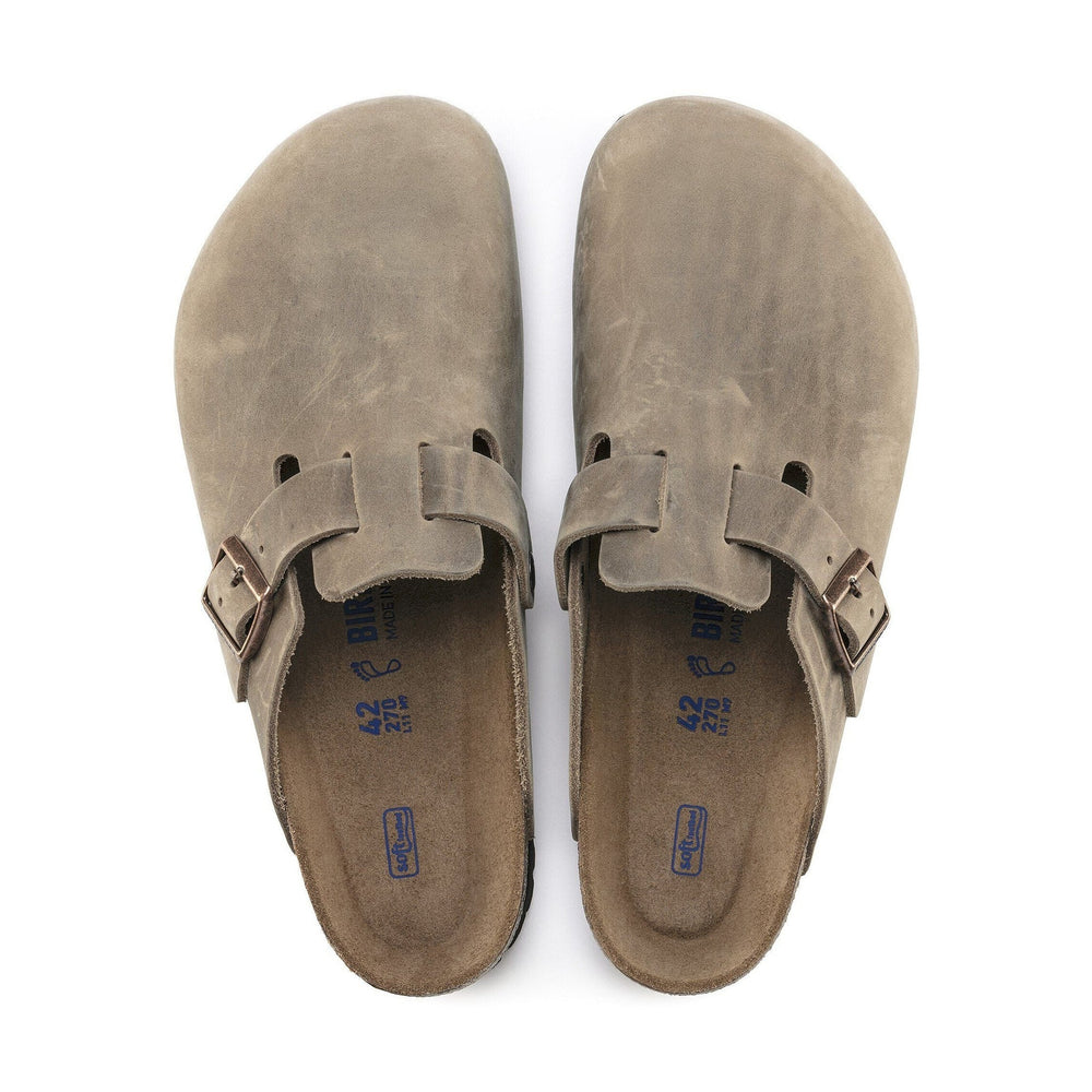 Pair of brown Birkenstock Boston Soft Footbed sandals with buckles on a white background