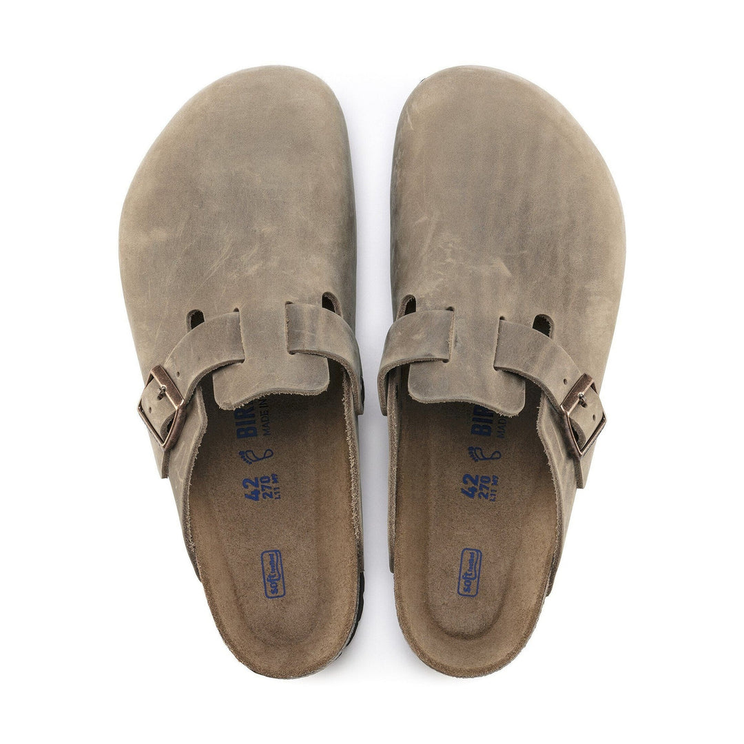 Pair of brown Birkenstock Boston Soft Footbed sandals with buckles on a white background