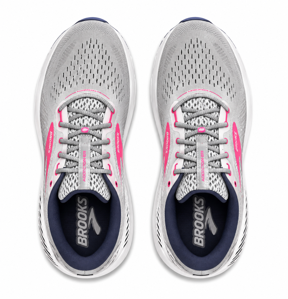 A pair of Brooks Addiction Gts 15 – Women's running shoes shown from a top-down view, featuring a light gray mesh upper with bright pink accents, navy blue lining, and white soles.